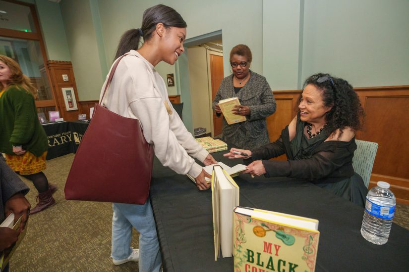 Alice Randall signs copies of her book, <i>My Black Country</i>, for students in the Live. Learn. Lead. Academy and others in Central Library on Nov. 20. (Harrison McClary/Vanderbilt)