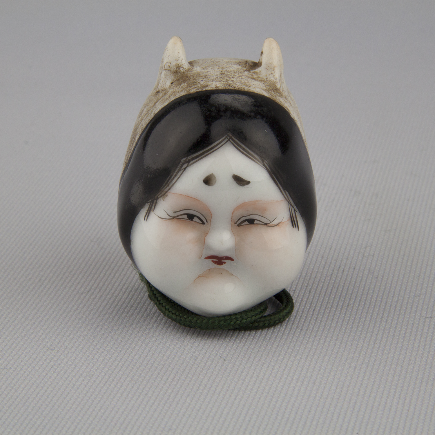 Netsuke depicting two masks: a female Noh face and a demon or guardian face, ca. 18th–19th century, glazed and unglazed porcelain, The Herman D. Doochin Collection, 1992.159
